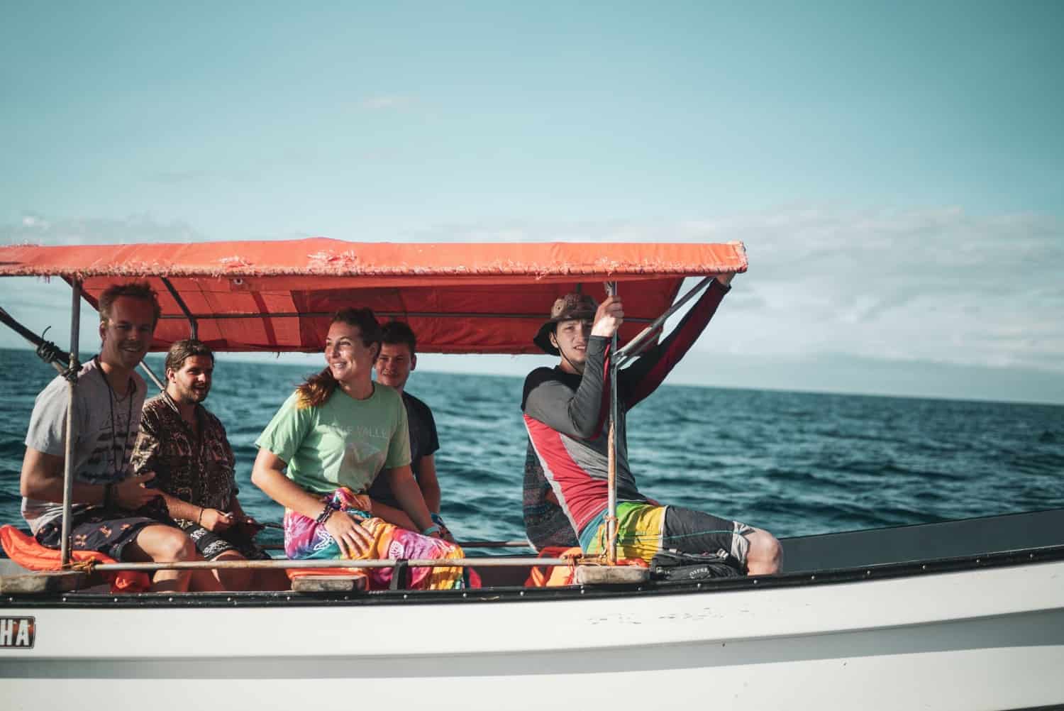 Group of people sailing in the middle of the ocean