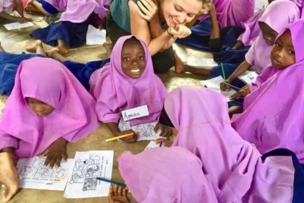 Marine Impact volunteers on a research boat in Menai Bay Zanzibar monitoring dolphin behaviour